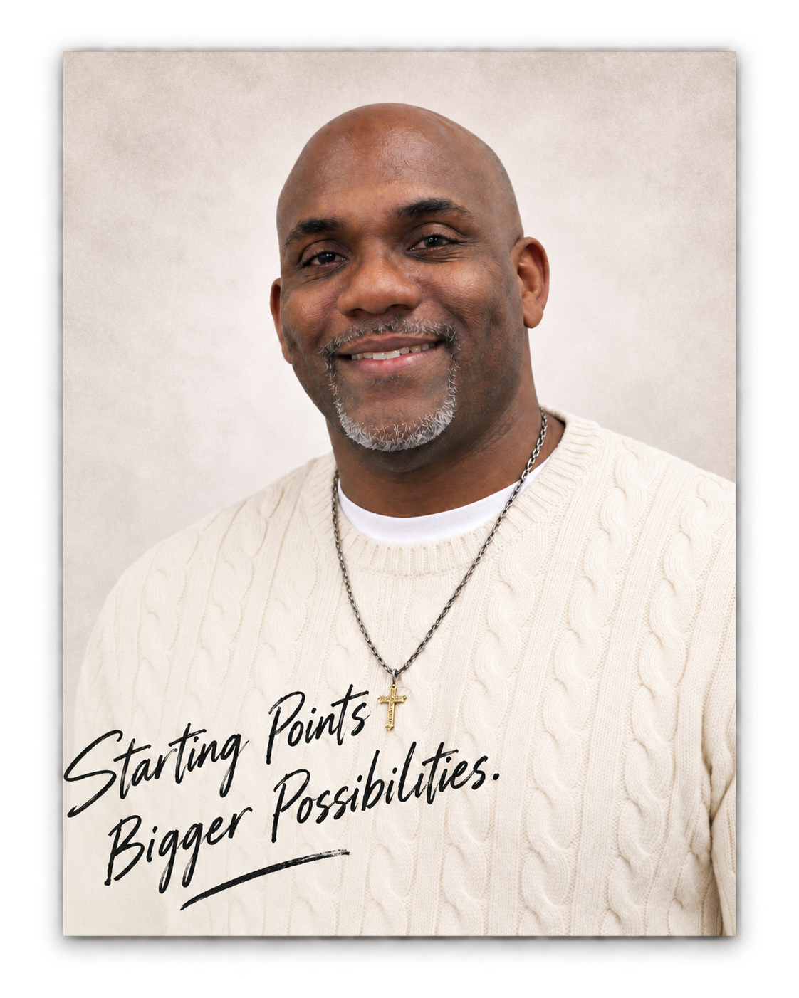 Portrait of Jermaine Fletcher in a cream sweater with the handwritten words Starting Points, Bigger Possibilities